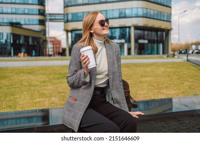 Woman holds a eco paper cup with coffee or tea and walks in spring park. Drink coffee time. Disposable paper cup. Take away. Hot beverage. Blank space.  - Powered by Shutterstock