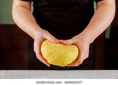 A Woman Holds Flaky Dough For Making Sugar Cookies.