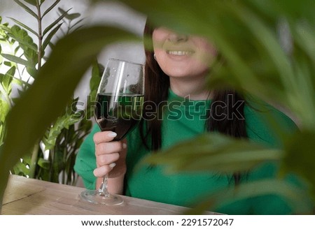 A woman holds a glass of chlorophyll water, an antioxidant drink. Healthy lifestyle, detox, chlorophyll, proper nutrition, oxygenation