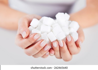 Woman Holds In Hands Of A Handful Of Sugar Cubes