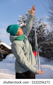 A Woman Holds A Huge Icicle In Her Hands In Nature