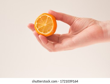  woman holds lemon blank for cosmetic home skin care, spa and natural cosmetics concept. Mockup, copy space