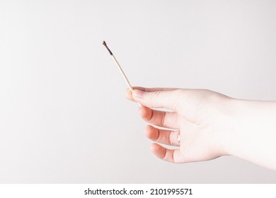 Woman Holds Matchstick. Space For Text