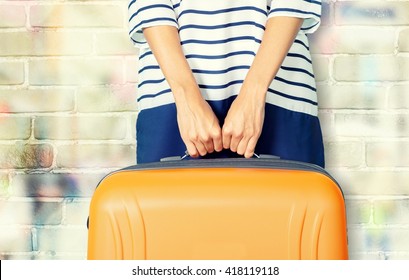 Woman Holds Orange Suitcase.