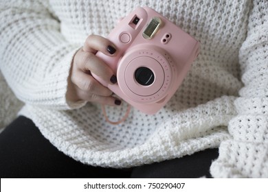 Woman Holds Pink Instant Camera