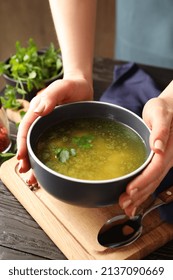 Woman Holds Plate Of Chicken Soup, Close Up