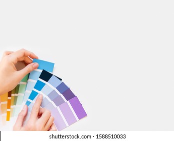 Woman Holds Rainbow Color Pallette On White Background. Designer Tool With Copy Space. Top View, Flat Lay.