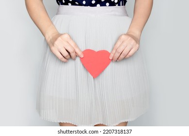 Woman Holds Red Heart Paper At Vagina As Pregnant. Vaginal Discharge, Uterus Problem, Pregnant.