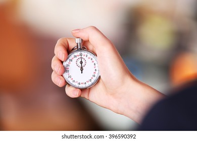 Woman holds stopwatch in hand, close up - Shutterstock ID 396590392