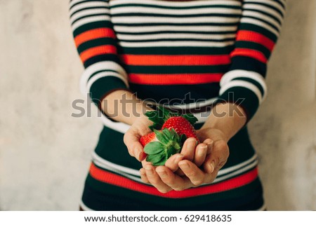 Similar – Woman holds strawberries in her hands