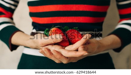 Similar – Woman holds strawberries in her hands