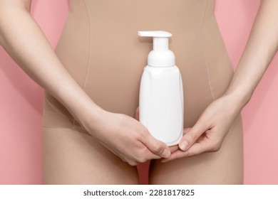Woman Holds White Bottle Of Hygiene Product, Washing, Cleansing Intimate Gel, Foam. Female Wears Beige Body On Pink Background. Mockup Branding Dispenser, Daily Body Care. Horizontal Plane, Closeup - Shutterstock ID 2281817825