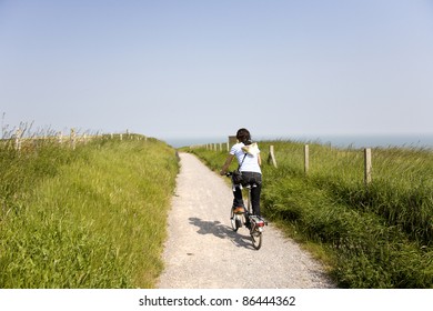 Woman In Holidays Cycling Around Dover, UK