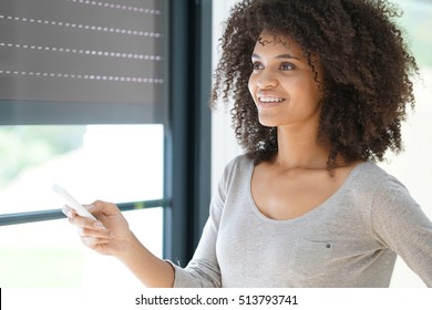 Woman At Home Controlling Shutter Opening