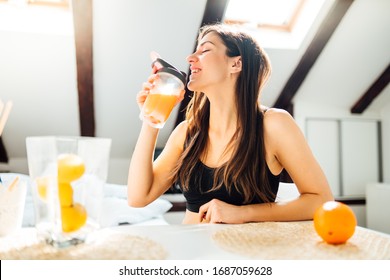 Woman At Home Drinking Orange Flavored Amino Acid Vitamin Powder.Keto Supplement.After Exercise Liquid Meal.Weight Loss Fitness Nutrition Diet.Immune System Support.Organic Citrus Fruit.Strong Body