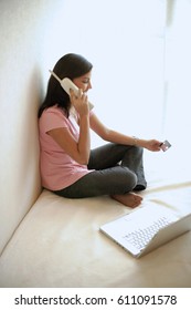 Woman At Home, Holding Credit Card, Using Cordless Phone