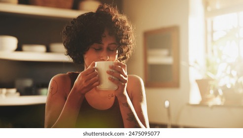 Woman, home and kitchen with cup of coffee on morning for breakfast, relax and enjoy. Female person, house and smile or satisfied with tea to chill, fun and day off with caffeine drink and peaceful - Powered by Shutterstock