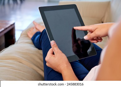 Woman At Home Relaxing On Sofa Couch Reading Email On The Tablet Computer Wifi Connection