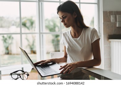 Woman at home in self isolation with laptop