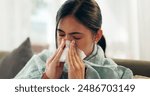 Woman, home and sinus with blowing nose on illness, flu and sick in living room on sofa. Female person, sneeze and couch in lounge with blanket for fever, virus and allergy with tissue for infection