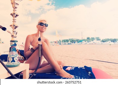 Woman With Hookah On The Beach In Bikini