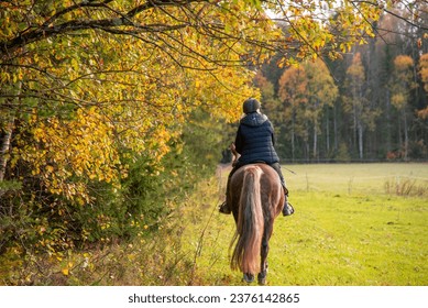 Woman horseback riding in autumn - Powered by Shutterstock