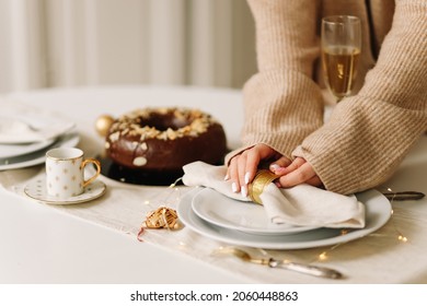 A Woman Hostess In A Knitted Cardigan Sets Plates On The Table Food And Drinks Decorates The Dining Festive Table Prepares For The Christmas Holiday In A Cozy House. Selective Focus