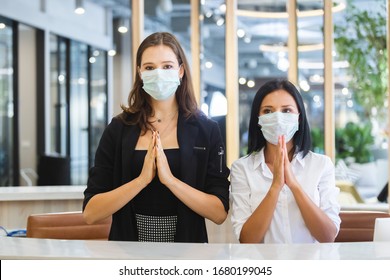 Woman Hotel Receptionist Wearing Medical Mask Greeting Thailand Style.
