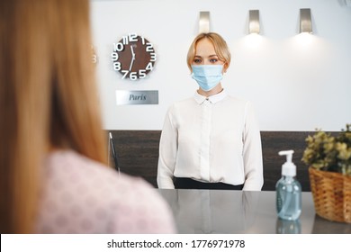 Woman Hotel Receptionist Wearing Medical Mask To Protect From Coronavirus Infection