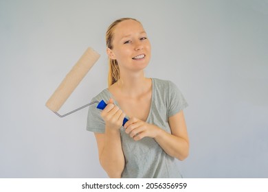 Woman House Painter Worker Painting And Priming Wall With Painting Roller. DIY