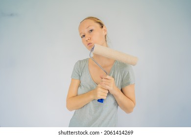 Woman House Painter Worker Painting And Priming Wall With Painting Roller. DIY