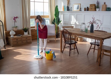 Woman Housemaid Tired Cleaning The Room
