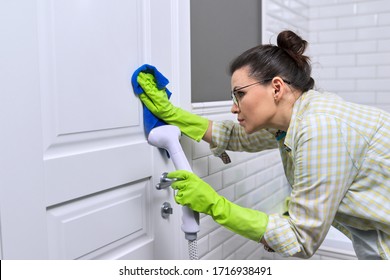 Woman Housewife Doing House Cleaning In Bathroom, Female Washing Door With Shower Steam. Using Steam Cleaner For Quick Cleaning