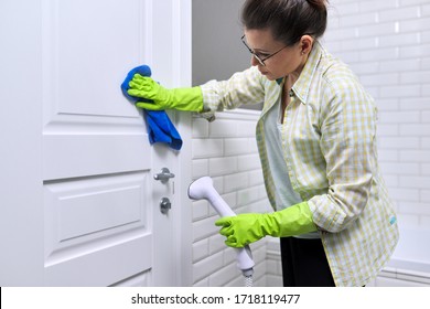 Woman Housewife Doing House Cleaning In Bathroom, Female Washing Door With Shower Steam. Using Steam Cleaner For Quick Cleaning