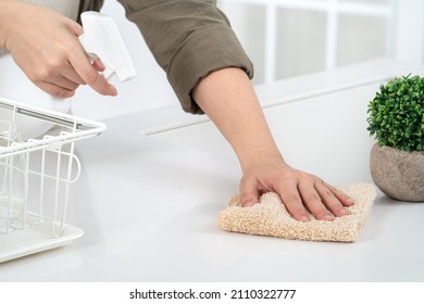 Woman Housewife Is Doing The Spring Cleaning At Home Kitchen With Using Rag, Spraying Bottle Cleaner To Wipe The Counter Table Surface.