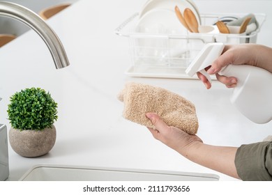 Woman Housewife Is Doing The Spring Cleaning At Home Kitchen With Using Rag, Spraying Bottle Cleaner To Wipe The Counter Table Surface.