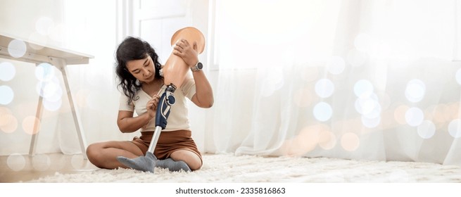 Woman hug prosthetic leg living room. applying leg prosthetic concept. Woman hug and checking and controlling quality prosthetic leg - Powered by Shutterstock