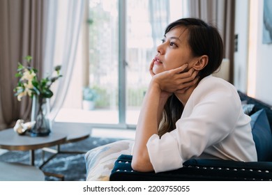 Woman Hug Self Body After Crying Looking Sad. Tired Girlfriend Cried Alone Doing Disappointed Pose Gesturing For Frustration. An Uncertain Asian Woman Sitting Knowing Relationship Is Uncomfortable.