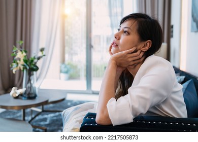 Woman Hug Self Body After Crying Looking Sad. Tired Girlfriend Cried Alone Doing Disappointed Pose Gesturing For Frustration. An Uncertain Asian Woman Sitting Knowing Relationship Is Uncomfortable.