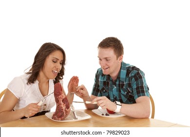 A Woman With A Huge Steak Getting Ready To Slap Her Dates Hand For Trying To Steal Some.