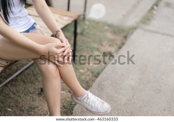 Woman hugged her\
knees,Girl sit with one\'s legs crossed,Waiting and relaxing\
concept,Vintage color\
style.