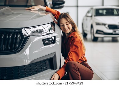 Woman Hugging A Car In A Car Showroom