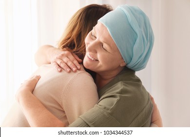 Woman Hugging Her Mother With Cancer Indoors