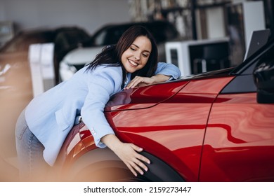 Woman Hugging Her New Red Car