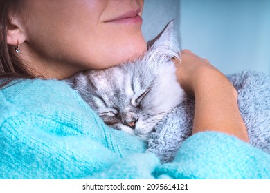 Woman Hugging Lovely Cat Sleeping In Her Arms Under Cozy Blanket. Pets And Human Love