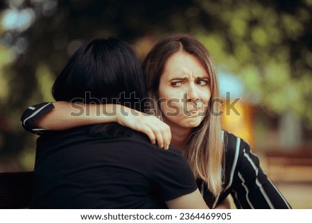 
Woman Hugs Fake Friend Making Faces Behind her Back 
Backstabbing toxic girlfriend embracing someone with bad intentions 
