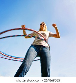 A Woman Hula Hooping On A Clear Day 
