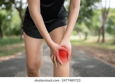 A woman is hurting her knee after running. Health problem concept, osteoarthritis problem. Running hard until injured. - Powered by Shutterstock