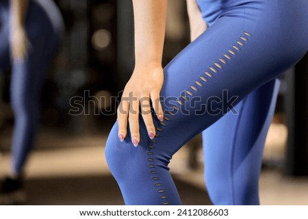 Woman hurting her legs at the gym