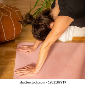 Woman With Hyper Extended Flexible Elbow Joint Exercising And Stretching On Yoga Mat In Downward Dog Pose. Special Joint Condition, Hypermobility. Close Up.